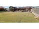 Vast backyard with lush lawn, mature landscaping, and an outdoor seating area showcasing the property's spaciousness at 21131 E Excelsior Ave, Queen Creek, AZ 85142