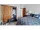 Bedroom featuring a closet with sliding doors, and cozy bed with blue patterned bedding, and ample lighting at 21131 E Excelsior Ave, Queen Creek, AZ 85142