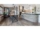 Rustic dining room with industrial-style table and chairs next to a modern kitchen at 21131 E Excelsior Ave, Queen Creek, AZ 85142
