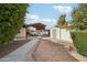Spacious driveway with covered parking and additional storage sheds providing convenience and ample room for vehicles and equipment at 21131 E Excelsior Ave, Queen Creek, AZ 85142