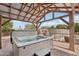 Relaxing backyard with a covered hot tub and view of the well-maintained garden landscape at 21131 E Excelsior Ave, Queen Creek, AZ 85142
