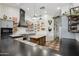 Bright kitchen features stainless appliances, custom vent hood, butcher block island, and white subway tile backsplash at 21131 E Excelsior Ave, Queen Creek, AZ 85142