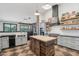 Spacious kitchen with large butcher block island, gray cabinets, stainless appliances, and open floor plan at 21131 E Excelsior Ave, Queen Creek, AZ 85142