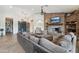 Spacious living room featuring a cozy stone fireplace, hardwood floors, and comfortable seating at 21131 E Excelsior Ave, Queen Creek, AZ 85142