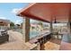 Beautiful outdoor covered bar area with seating and view of the pool and waterfall feature at 21131 E Excelsior Ave, Queen Creek, AZ 85142