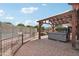 Outdoor patio with a spa, wooden pergola, and a partial view of the pool, perfect for relaxation and recreation at 21131 E Excelsior Ave, Queen Creek, AZ 85142