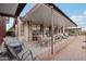Expansive covered patio featuring a built-in bar, dining area, and comfortable seating, perfect for outdoor entertaining at 21131 E Excelsior Ave, Queen Creek, AZ 85142