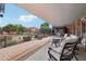 Covered brick patio with outdoor seating, views of the yard, and a pergola at 21131 E Excelsior Ave, Queen Creek, AZ 85142