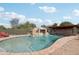 Backyard pool featuring a rock waterfall, water features, and covered sitting area at 21131 E Excelsior Ave, Queen Creek, AZ 85142