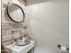 Stylish powder room featuring shiplap accent wall, round mirror, vessel sink, and unique fixtures for rustic charm at 21131 E Excelsior Ave, Queen Creek, AZ 85142