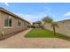 Spacious backyard featuring a well-maintained artificial lawn, brick patio, and a cozy pergola at 2148 W Angelo Way, San Tan Valley, AZ 85144