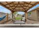 Relaxing backyard with covered patio, pavers, seating and turf at 2148 W Angelo Way, San Tan Valley, AZ 85144