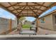 Relaxing backyard with covered patio, pavers, seating and turf at 2148 W Angelo Way, San Tan Valley, AZ 85144