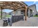 Relaxing backyard with covered patio, pavers, seating and turf at 2148 W Angelo Way, San Tan Valley, AZ 85144