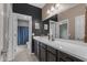 Well-lit bathroom featuring a spacious vanity and a view into the shower room at 2148 W Angelo Way, San Tan Valley, AZ 85144