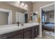 Spacious bathroom vanity with a sink and a clear view into the adjacent bedroom at 2148 W Angelo Way, San Tan Valley, AZ 85144