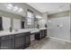 This bathroom offers dual sinks, a large vanity, a glass enclosed shower, and tile floors at 2148 W Angelo Way, San Tan Valley, AZ 85144