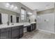 This bathroom offers dual sinks, a large vanity, a glass enclosed shower, and tile floors at 2148 W Angelo Way, San Tan Valley, AZ 85144