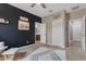 Bedroom featuring stylish black accent wall, a patterned rug, and an ensuite bathroom at 2148 W Angelo Way, San Tan Valley, AZ 85144