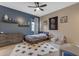 Cozy bedroom featuring a ceiling fan, rug, and a combination of blue and neutral wall paint at 2148 W Angelo Way, San Tan Valley, AZ 85144