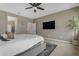 This primary bedroom boasts neutral walls, a ceiling fan, and a mounted television at 2148 W Angelo Way, San Tan Valley, AZ 85144