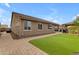 Exterior view of the home showcasing a backyard with artificial turf and brick pavers at 2148 W Angelo Way, San Tan Valley, AZ 85144