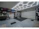 Spacious three car garage with epoxy floors, custom lighting and organization at 2148 W Angelo Way, San Tan Valley, AZ 85144