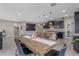 Open floor plan with dining table flowing into the kitchen with a central island and stylish pendant lights at 2148 W Angelo Way, San Tan Valley, AZ 85144