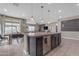 Open concept kitchen island featuring a sink, dishwasher, and cabinets with pendant lighting above at 2148 W Angelo Way, San Tan Valley, AZ 85144