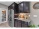 Beautiful kitchen with stainless steel appliances, dark cabinetry and granite counters for a modern aesthetic at 2148 W Angelo Way, San Tan Valley, AZ 85144