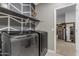 This laundry room is equipped with stainless steel washer and dryer and decorative elements at 2148 W Angelo Way, San Tan Valley, AZ 85144