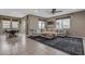 Spacious living room featuring a sectional sofa, large rug, and ample natural light from the windows at 2148 W Angelo Way, San Tan Valley, AZ 85144
