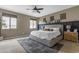 Serene main bedroom featuring a king-size bed, soft carpeting, and neutral tones for a relaxing ambiance at 2148 W Angelo Way, San Tan Valley, AZ 85144