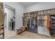 This walk-in closet features custom shelving and ample storage space, as well as a laundry area at 2148 W Angelo Way, San Tan Valley, AZ 85144