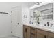 Stylish bathroom with double sinks, a modern mirror, and decorative floral arrangement at 21539 N 72Nd Pl, Scottsdale, AZ 85255