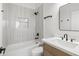 Elegant bathroom with marble-look tile, soaking tub, and modern black fixtures at 21539 N 72Nd Pl, Scottsdale, AZ 85255