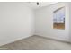 Carpeted bedroom with natural light from a window, showcasing a simple and inviting space at 21539 N 72Nd Pl, Scottsdale, AZ 85255