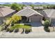 Beautiful single-story home featuring a lush, well-maintained front yard with mature trees and desert landscaping at 21539 N 72Nd Pl, Scottsdale, AZ 85255