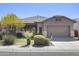 Charming single-story home with a well-manicured lawn, mature trees, and a two-car garage at 21539 N 72Nd Pl, Scottsdale, AZ 85255