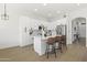 Bright kitchen with white cabinets, stainless steel appliances, and modern fixtures with island and bar seating at 21539 N 72Nd Pl, Scottsdale, AZ 85255