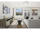Stylish living room with modern sofa, neutral decor, large windows, and natural light at 21539 N 72Nd Pl, Scottsdale, AZ 85255
