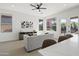 Bright living room featuring a modern couch, entertainment center and windows with views to outdoors at 21539 N 72Nd Pl, Scottsdale, AZ 85255