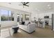 Bright, open-concept living space with modern furnishings, light wood floors, and kitchen in the background at 21539 N 72Nd Pl, Scottsdale, AZ 85255