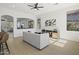 Bright living room featuring modern furniture and a view into the kitchen with bar seating at 21539 N 72Nd Pl, Scottsdale, AZ 85255