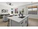 Bright living space with kitchen island and view into living room showcasing open concept and outside views at 21539 N 72Nd Pl, Scottsdale, AZ 85255