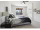 Comfortable main bedroom with a tufted headboard, stylish bedding, and a view to the patio at 21539 N 72Nd Pl, Scottsdale, AZ 85255
