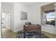 Modern office with a dark wood desk, decorative rug, and bright window views and plenty of light at 21539 N 72Nd Pl, Scottsdale, AZ 85255