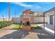 A wooden playhouse is the focal point in the artificial grass backyard at 2313 N 66Th St, Scottsdale, AZ 85257
