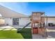 The backyard features artificial grass, a playhouse, and a shade canopy at 2313 N 66Th St, Scottsdale, AZ 85257