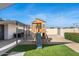 Charming backyard features a playhouse with a slide and lush artificial grass at 2313 N 66Th St, Scottsdale, AZ 85257